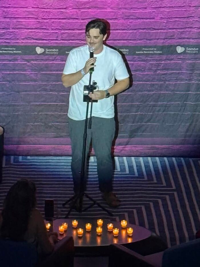 A comedian performing for the Sober and Shameless audience in Savannah